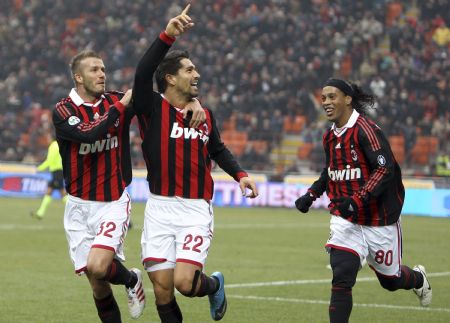 AC Milan's Marco Borriello (C) celebrates with his team mate Ronaldinho (R) and David Beckham after scoring against Siena in their Italian Serie A soccer match at San Siro stadium in Milan, January 17, 2010.