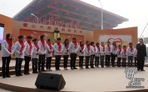 Expo volunteers and charity workers are given red ribbons at the ceremony