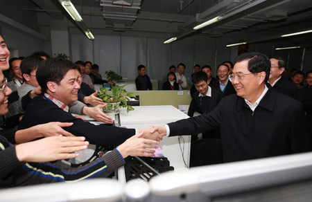 Hu Jintao (R front), general secretary of the Central Committee of the Communist Party of China, Chinese president and chairman of the Central Military Commission, shakes hands with young members of the research and development team as he inspects Spreadtrum Communications, Inc., in Shanghai, east China, on Jan. 16, 2010. Hu Jintao made an inspection tour in Shanghai on Jan. 14-17. [Xinhua] 