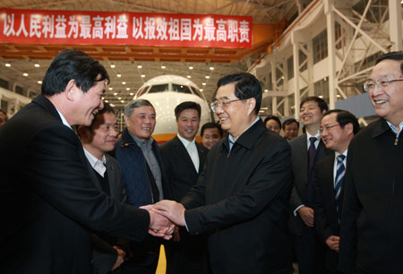 Hu Jintao (C, front), general secretary of the Central Committee of the Communist Party of China, Chinese president and chairman of the Central Military Commission, inspects Shanghai Aircraft Manufacturing Co., Ltd. of Commercial Aircraft Corporation of China Ltd. (COMAC) in Shanghai, east China, on Jan. 14, 2010. Hu Jintao made an inspection tour in Shanghai on Jan. 14-17. [Xinhua] 