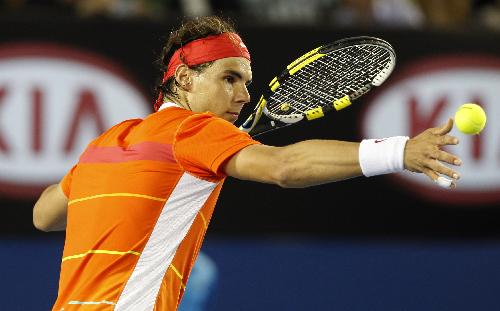 Rafael Nadal of Spain strikes the ball to the spectators to celebrate his victory after the first round match of men's singles against Peter Luczak of Australia during 2010 Australian Open in Melbourne, Australia, Jan. 18, 2010. (Xinhua/Wang Lili)