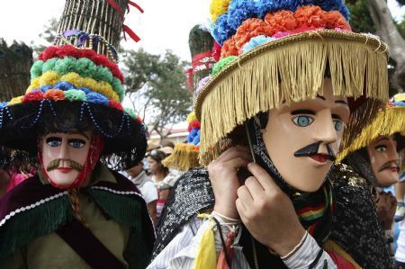 Parishioners wearing Saint Sebastian masks prepare to dance in the streets of Diriamba, about 45 km (28 miles) south of the capital, as they mark the Feast of Saint Sebastian January 20, 2010.[Xinhua/Reuters]