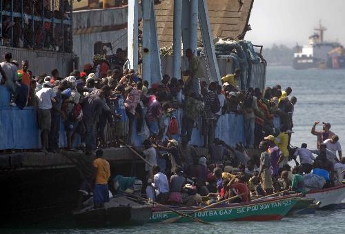 Local citizens try to flee this destroyed city by boat in Port-au-Prince, Haiti, Jan. 20, 2010. A 7.0 magnitude earthquake hit the country on Jan. 12, 2010. (Xinhua/David de la Pas)