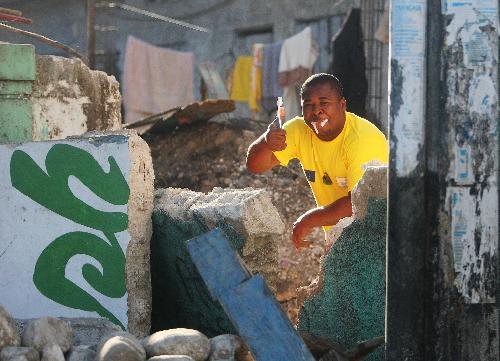 A man brushes teeth at his ruined home in Port-au-Prince, capital of Haiti, on Jan. 22, 2010, ten days after a catastrophic earthquake hit the nation on Jan. 12.