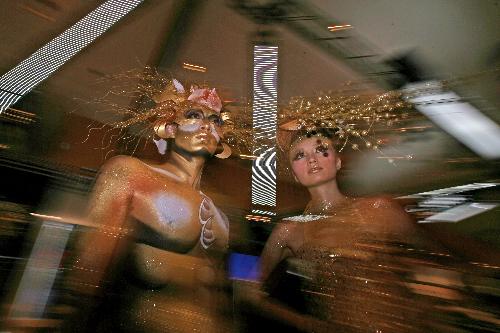 Models present golden body paintings at a department store in Wuhan, capital of central-south China's Hubei Province, Jan. 22, 2010.