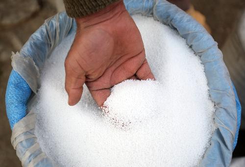 An Afghan seller shows fertilizer at his shop in the Afghan capital Kabul, Jan. 24, 2010. Since Taliban militants used the fertilizer type ammonium nitrate to make bombs, the Afghan government on Sunday formally banned using, producing and selling the item, and asked the shopkeepers and owners to finish the contraband within a month. (Xinhua/Zabi Tamanna)