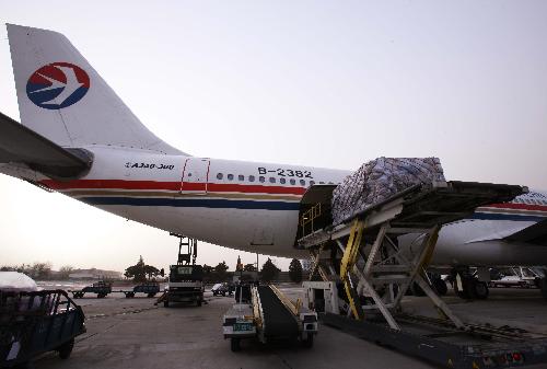 Medical supplies are loaded to a chartered plane bound to Haiti, in Beijing, capital of China, on Jan. 24, 2010. A 40-member Chinese medical care and epidemic prevention team left here for Haiti on Sunday afternoon on a chartered flight, which also carried 20 tonnes of medical supplies. [Xinhua]