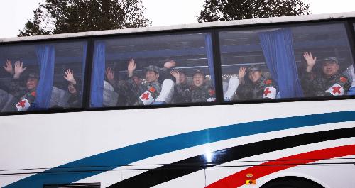 Members of Chinese medical care and epidemic prevention team arrive at the airport to aboard a plane to Haiti, in Beijing, capital of China, on Jan. 24, 2010. A 40-member Chinese medical care and epidemic prevention team left here for Haiti on Sunday afternoon on a chartered flight, which also carried 20 tonnes of medical supplies. 