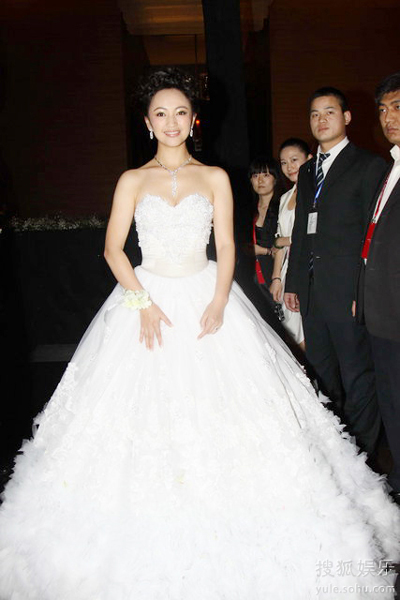 The bride Luo Haiqiong poses for photography in a fluffy fairy-tale wedding dress during her wedding ceremony at the hotel Park Hyatt in Beijing Sunday evening, Jan. 24, 2010.