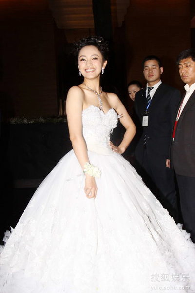 The bride Luo Haiqiong poses for photography in a fluffy fairy-tale wedding dress during her wedding ceremony at the hotel Park Hyatt in Beijing Sunday evening, Jan. 24, 2010. 