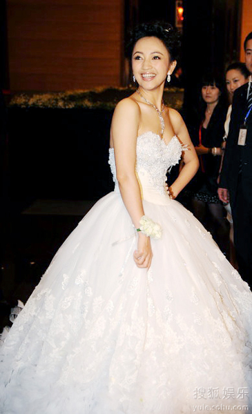 The bride Luo Haiqiong poses for photography in a fluffy fairy-tale wedding dress during her wedding ceremony at the hotel Park Hyatt in Beijing Sunday evening, Jan. 24, 2010.