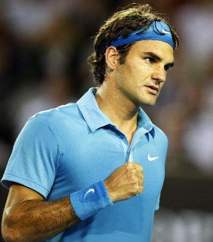 Roger Federer of Switzerland celebrates for a score during the fourth round match of men's singles against Lleyton Hewitt of Australia in 2010 Australian Open Tennis Championship in Melbourne, Australia, Jan. 25, 2010. (Xinhua/Wang Lili)