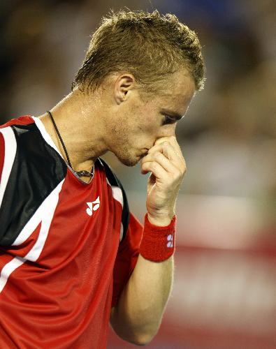 Lleyton Hewitt of Australia reacts during the fourth round match of men's singles against Roger Federer of Switzerland in 2010 Australian Open Tennis Championship in Melbourne, Australia, Jan. 25, 2010. (Xinhua/Wang Lili) 