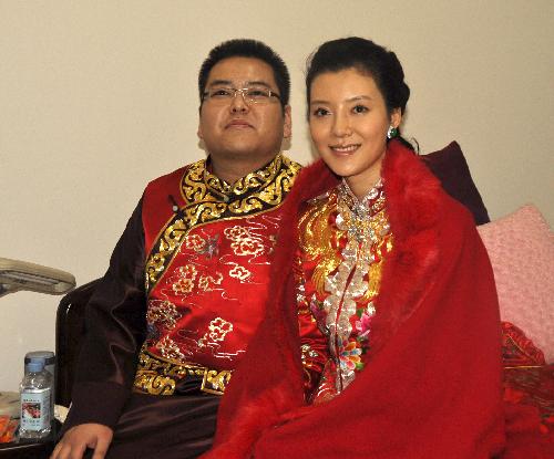 Bridegroom Li Zhaohui and his bride Che Xiao sit together inside the bridal chamber, during their marriage ceremony in traditional Chinese style, in Wenxi County, Shanxi Province, Jan. 25, 2010.