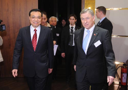 Chinese Vice Premier Li Keqiang (L) and Gerold Buehrer, president of Economiesuisse step into the room during a dinner party held by the Economiesuisse, the Swiss Business Federation, at Zurich on Jan. 25, 2010. Li Keqiang arrived here on Monday for a four-day official visit to Switzerland, during which he will also attend this year&apos;s World Economic Forum (WEF) annual meeting in Davos. (Xinhua/Fan Rujun)