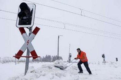 A worker clears a railway crossing near the village of Gross Kiesow in northern Germany January 11, 2010. 