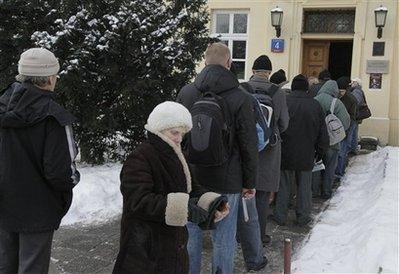 People waiting in line to receive food donations from a church charity organization under harsh winter weather of sub-freezing temperatures and heavy snowfall in Warsaw, Poland, on Friday, Jan .8, 2010. Some 139 people have frozen to death across Poland since cold weather hit in November. 