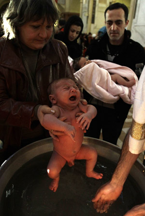 Children are baptised during a mass baptism ceremony in Tbilisi, January 27, 2010. About 500 children were baptised by the Georgian Orthodox church during a mass baptism ceremony at the country&apos;s main cathedral Holy Trinity.[Xinhua/Reuters] 