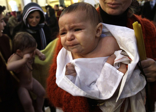 Children are baptised during a mass baptism ceremony in Tbilisi, January 27, 2010. About 500 children were baptised by the Georgian Orthodox church during a mass baptism ceremony at the country&apos;s main cathedral Holy Trinity.[Xinhua/Reuters] 