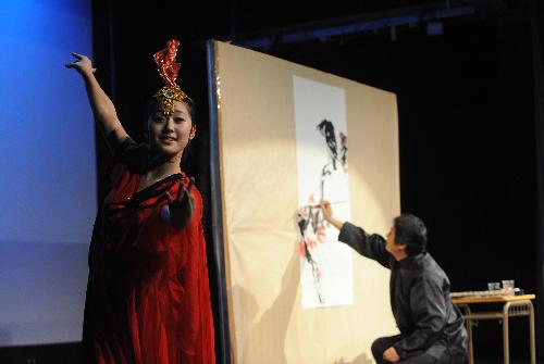 Teachers and students of the art troupe of China&apos;s Northeast Normal University dance and perform Chinese painting and calligraphy at the Nicolas Salmeron Culture Center in Madrid, capital of Spain, Jan. 27, 2010. [Xinhua] 