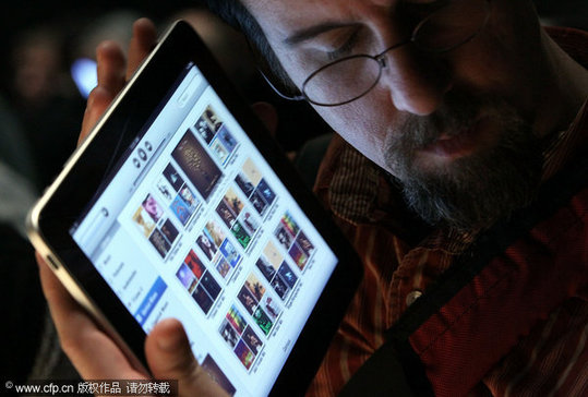 An event guest plays with the new Apple iPad during an Apple Special Event at Yerba Buena Center for the Arts January 27, 2010 in San Francisco, California. CEO Steve Jobs and Apple Inc. introduced its latest creation, the iPad, a mobile tablet browsing device that is a cross between the iPhone and a MacBook laptop. 