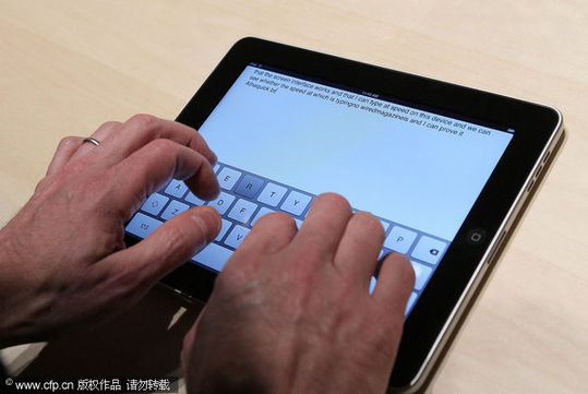 An event guest plays with the new keyboard on a Apple iPad during an Apple Special Event at Yerba Buena Center for the Arts January 27, 2010 in San Francisco, California. CEO Steve Jobs and Apple Inc. introduced its latest creation, the iPad, a mobile tablet browsing device that is a cross between the iPhone and a MacBook laptop.[CFP]