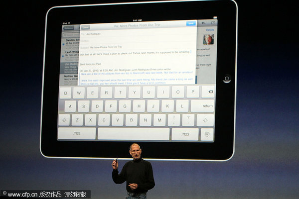 Apple Inc. CEO Steve Jobs demonstrates the new iPad as he speaks during an Apple Special Event at Yerba Buena Center for the Arts January 27, 2010 in San Francisco, California. Apple introduced its latest creation, the iPad, a mobile tablet browsing device that is a cross between the iPhone and a MacBook laptop. [CFP]