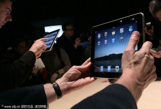 Event guests play with the new Apple iPad during an Apple Special Event at Yerba Buena Center for the Arts January 27, 2010 in San Francisco, California. CEO Steve Jobs and Apple Inc. introduced its latest creation, the iPad, a mobile tablet browsing device that is a cross between the iPhone and a MacBook laptop. [CFP]