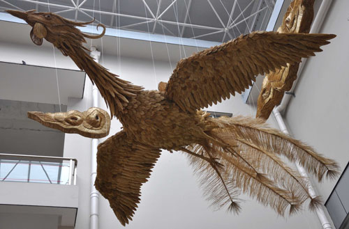 Photo taken on Jan. 27, 2010 shows the hand-woven straw handicraft of two pairs of 30-meter-long phoenixes with the connotation of bringing forth auspices and prosperity, on the building of the Liuzhou Museum in Liuzhou, southwest China&apos;s Guangxi Zhuang Autonomous Region. [Xinhua]