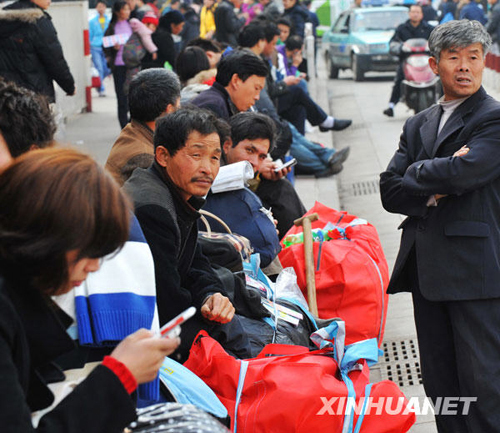 People wait for buying tickets in Changsha Railway Station, Hunan Province, on January 19, 2010. 