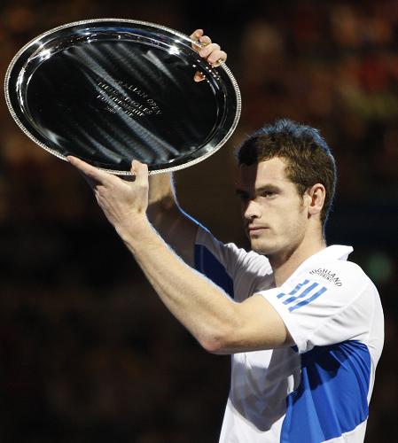 Andy Murray of Britain poses with his trophie during the awarding ceremony after the final match of men&apos;s singles at 2010 Australian Open Tennis Championship at Rod Laver Arena in Melbourne, Australia, Jan. 31, 2010. Federer won 3-0. [Xinhua]