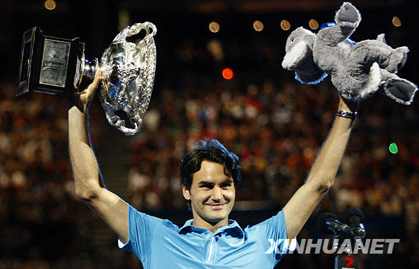 Roger Federer of Switzerland holds up the champion trophy and koala doll during the awarding ceremony after the final match of men&apos;s singles against Andy Murray of Britain at 2010 Australian Open Tennis Championship at Rod Laver Arena in Melbourne, Australia, Jan. 31, 2010. Federer won 3-0. [Xinhua]