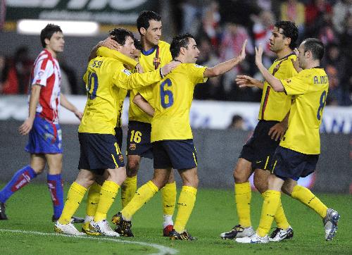 FC Barcelona's members celebrate after scoring against Sporting de Gijon during their Spanish La Liga soccer match at El Molinon stadium in Gijon northern Spain, Saturday Jan. 30, 2010. Barcelona won 1-0.(Xinhua/Reuters Photo)