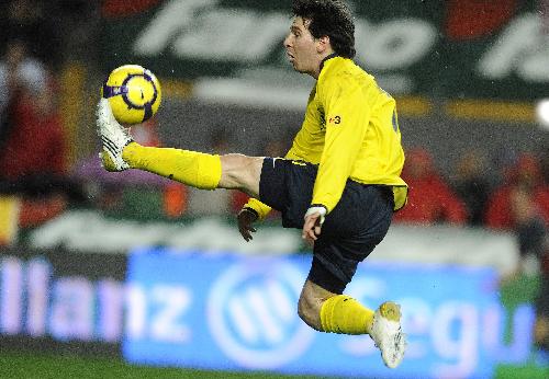 FC Barcelona's Lionel Messi from Argentina controls the ball during his Spanish La Liga soccer match against Sporting Gijon at El Molinon stadium in Gijon northern Spain, Saturday Jan. 30, 2010.(Xinhua/Reuters Photo)