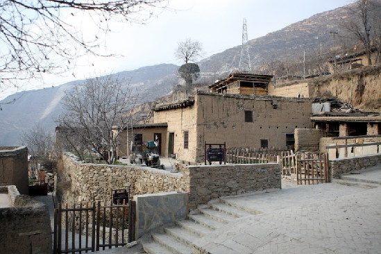This photo, taken Jan. 26, shows the old-world Qiang ethnic village Buwa in Wenchuan County, Sichuan Province. Most houses in Buwa were destroyed in the 2008 Sichuan earthquake. All roads and houses have been rebuilt since. Three ethnic watchtowers built with yellow mud are also under reinforcement and construction. Buwa is located on the west coast of Min River. [China.org.cn/ Zhao Xi]