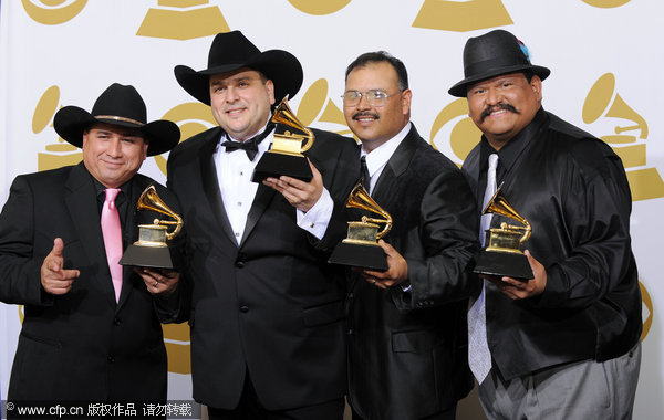 Los Texmaniacs, from left, David Farias, Max Baca, Oscar Garcia and Lorenzo Martinez hold awards for best tejano album for 'Borders y Bailes,' backstage at the 52nd Grammy Awards on Sunday, Jan. 31, 2010, in Los Angeles.