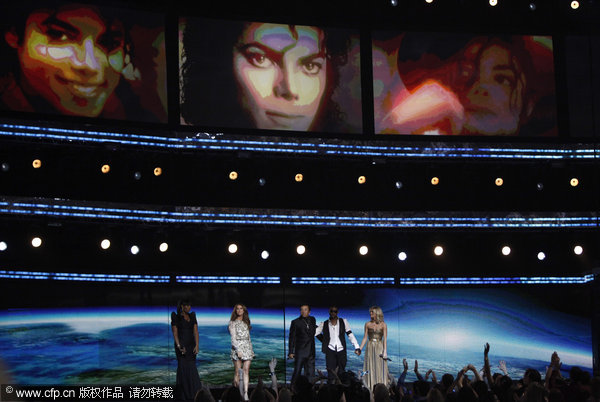 From left, Jennifer Hudson, Celine Dion, Smokey Robinson, Usher and Carrie Underwood perform during a tribute in honor of Michael Jackson at the 52nd Annual Grammy Awards on Sunday, Jan. 31, 2010, in Los Angeles.