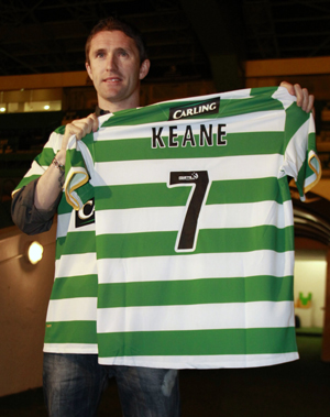 Robbie Keane poses for photographers holding a club jersey at Celtic Park stadium in Glasgow, Scotland February 1, 2010. Ireland skipper Keane left Tottenham Hotspur for Celtic on loan on Monday, a year after rejoining Spurs from a short-lived spell at Liverpool. (Xinhua/Reuters Photo) 