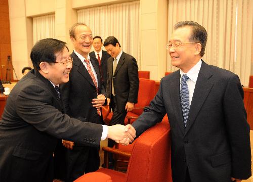 Chinese Premier Wen Jiabao (R) shakes hands with a representative during a meeting on the government's work report in Beijing Jan. 29, 2010. The Premier presided over five meetings from Jan. 22 to Feb. 1, to solicit opinions from representatives and experts from democratic parties, business circles and various citizen groups on the government's work report, which is to be submitted at the upcoming annual session of the National People's Congress. [Xinhua]