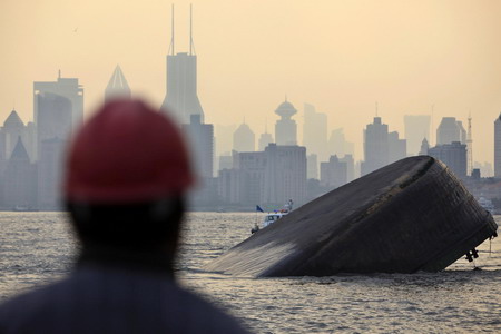 A view shows a sinking cargo ship after it collided with a boat on Huangpu River in Shanghai February 1, 2010.