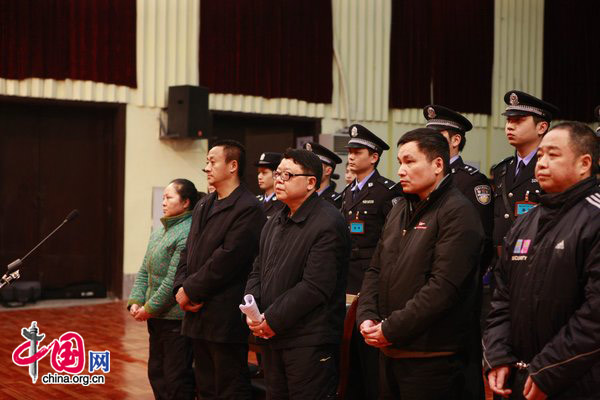 At 9:30 am on February 2, 2010, Wen Qiang, formal deputy director of Public Security Bureau, and head of the Bureau of Justice of Chongqing Municipality (3rd from the left, front row) and his wife Zhou Xiaoya stand for trial. [CFP]