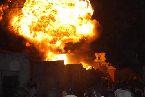 Huge fire engulfs part of the main Bakara Market, where fuel in barrels and tanks is sold, in Mogadishu, capital of Somalia, Feb. 2, 2010. The fire destroyed hundreds of thousands of dollars&apos; worth of goods, mainly petrol and diesel. [Ismail Warsameh/Xinhua]
