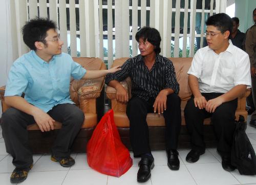 Officials of Chinese Embassy to Indonesia Wang Minhao(L) and Sun Jie (R) comfort the survivor Ke Kaishen (C) in Moluccas islands in eastern Indonesia, Feb. 2, 2010. Rescuers continued to search for the 23 missing passengers of the sunken Dolphin speed boat off Moluccas islands on Tuesday. There were more than 30 people including 24 Chinese citizens on board the Dolphin speed boat when it sank on Jan. 27. [Xinhua/Yue Yuewei]