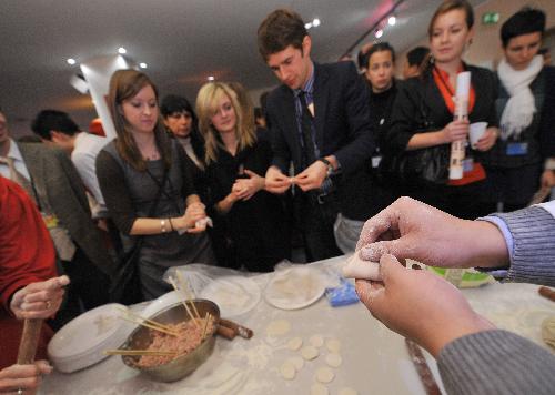 Guests learn to make Chinese dumplings during a cultural presentation of the Chinese lunar new year at the European Parliament headquarters in Brussels, capital of Belgium, Feb. 2, 2010. [Wu Wei/Xinhua]