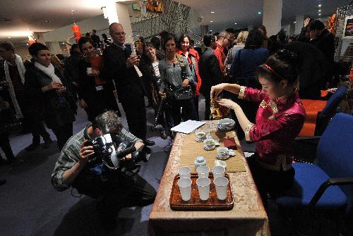 A girl performs Chinese tea ceremony during a cultural presentation of the Chinese lunar new year at the European Parliament headquarters in Brussels, capital of Belgium, Feb. 2, 2010.