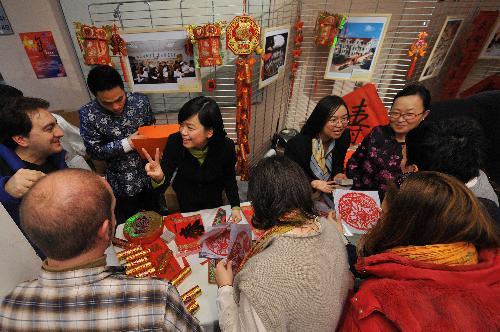 Guests look at Chinese Spring Festival decorations during a cultural presentation of the Chinese lunar new year at the European Parliament headquarters in Brussels, capital of Belgium, Feb. 2, 2010. 