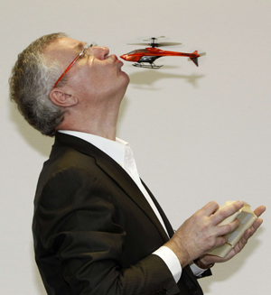 Designer Alexander van de Rostyne kisses his new and first 4-channel indoor toy helicopter from the company Silverlit during the press preview of the 61st International Toy Fair in Nuremberg February 3, 2010. More than 2,700 exhibitors from over 60 countries worldwide will present their new toy products from February 4 to February 9, 2010.[Xinhua/Reuters Photo]