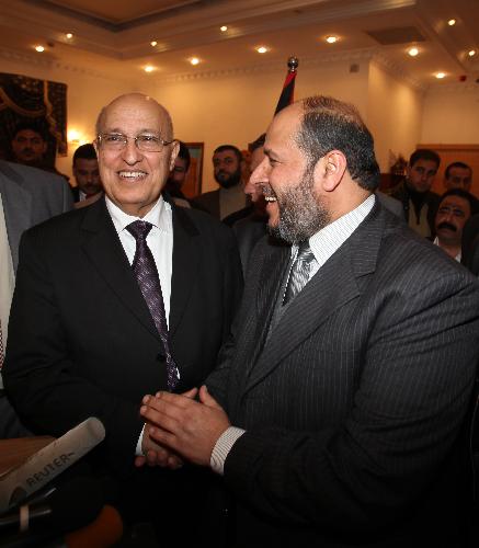 Nabil Shaath (L), member of Fatah Central Committee, shakes hands with senior Hamas leader Khalil al-Hayya following their meeting in Gaza City, Feb. 3, 2010. [Wissam Nassar/Xinhua]