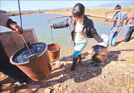 Villagers in Yiliang county, Yunnan province, fetch drinking water from afar on Tuesday. 