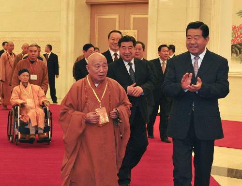 Jia Qinglin (front R), chairman of the National Committee of the Chinese People's Political Consultative Conference(CPPCC), walks with Chuan Yin (front L), the newly elected president of the Buddhist Association of China, in Beijing, capital of China, Feb. 3, 2010. Jia met with the delegates of the eighth national conference of the Buddhist Association of China in Beijing on Wednesday.